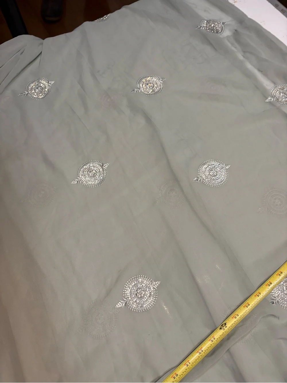 218” Legnth sage green draped saree features delicate silver embroidery